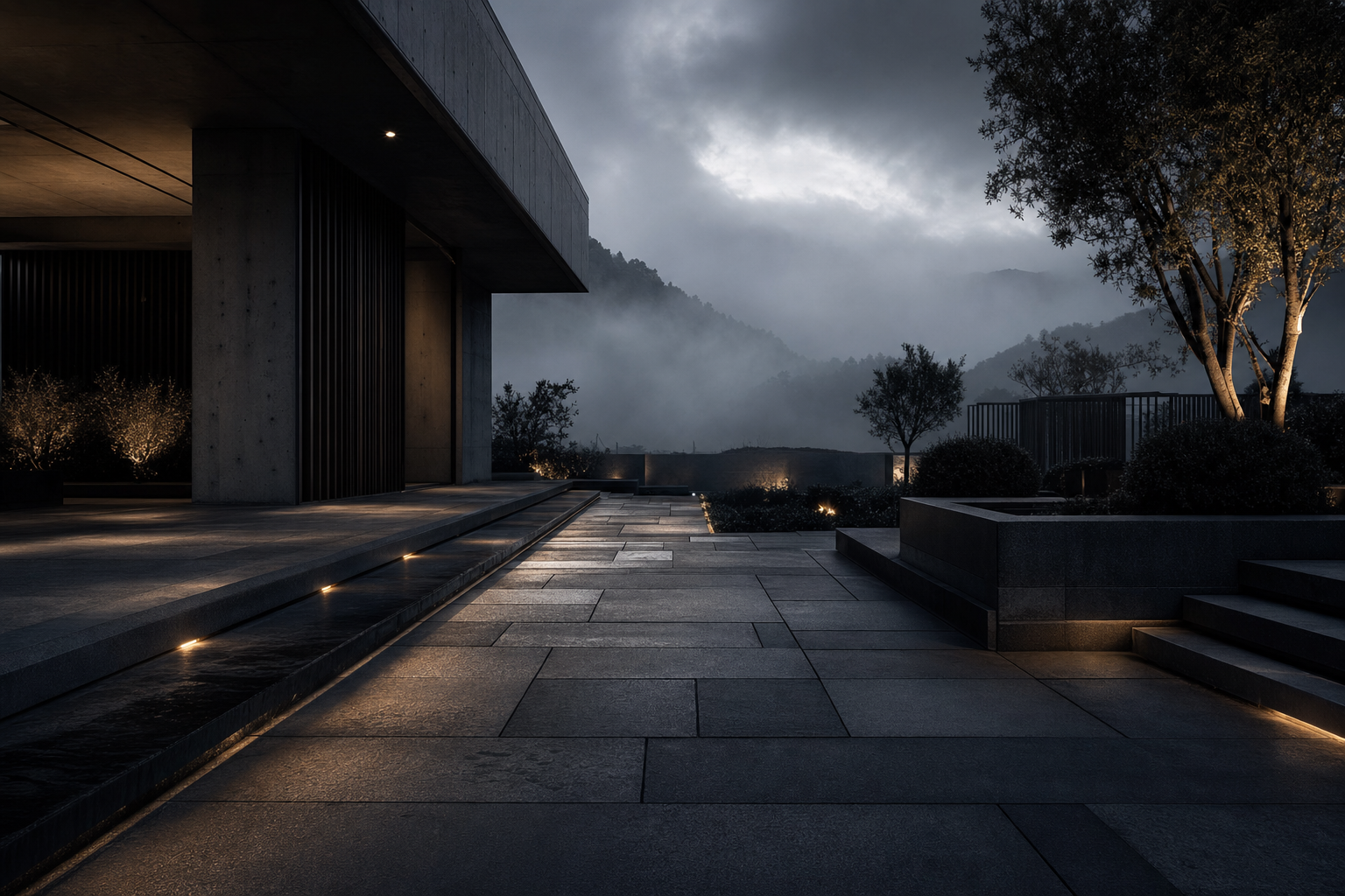 Patio brutaliste en pavé de béton noir au crépuscule, montagnes dans la brume